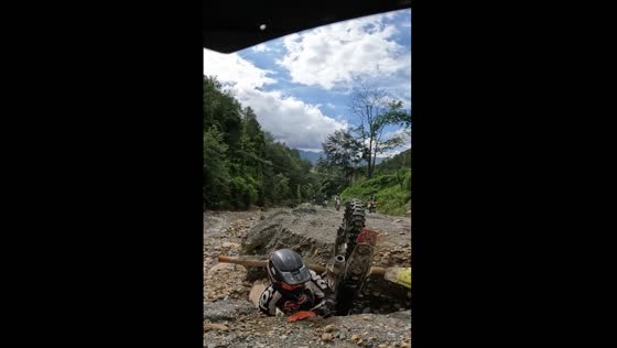 Biker falls into unexpected road hole in Kathmandu, Nepal