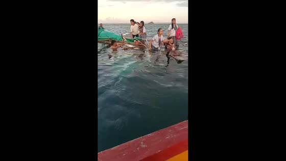 Boat carrying students rescued during high water in Claver, Philippines