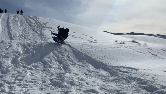 Two people lose control while snow tubing down ramp in Xinjiang, China