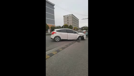 White car missing a tire moving off the road in Jiangsu, China