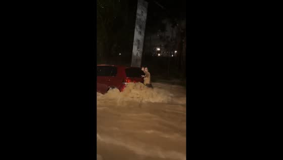 Woman stands on vehicle calling for help during flash flood in Fujian, China
