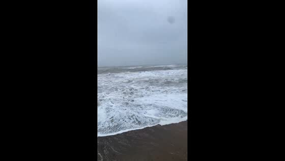 Massive waves crashing against the seawall in Youghal, County Cork, Ireland