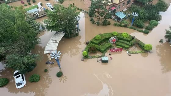 Rising floodwaters inundate homes and vehicles in Jilin, China