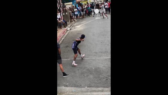 Youth enthusiastically play Vitilla in Herrera, Dominican Republic