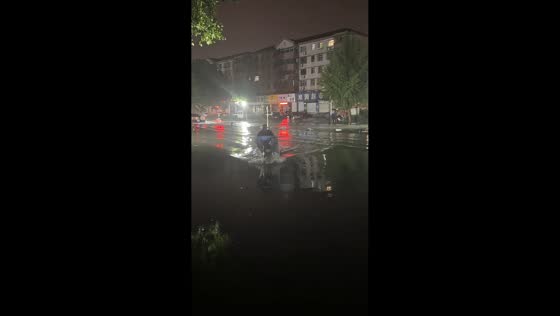 E-scooter rider falls into flooded street after hitting gutter in Hebei, China