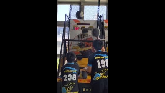 Two boys show perfect shooting skills in arcade game in Taichung, Taiwan