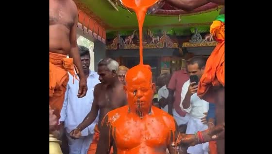 Person anointed with chili liquid during Thaipusam festival in Sidthathur village