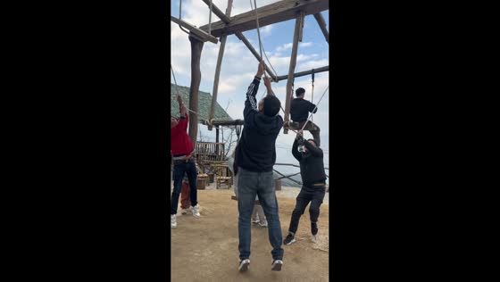 Woman struggle with uneven seat on wooden Ferris wheel in Yunnan, China