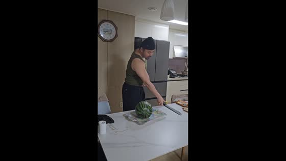 Man cracks table while slicing watermelon in kitchen in Hongseong-gun, South Korea