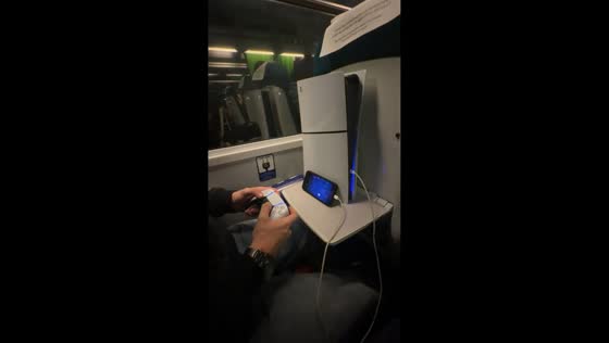 Passenger plays PlayStation 5 Slim via Remote Play on train in Lisbon, Portugal