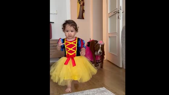 Dog and daughter in funny clothes
