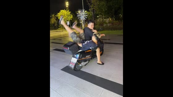 Passenger falls during scooter trick in Guangdong, China