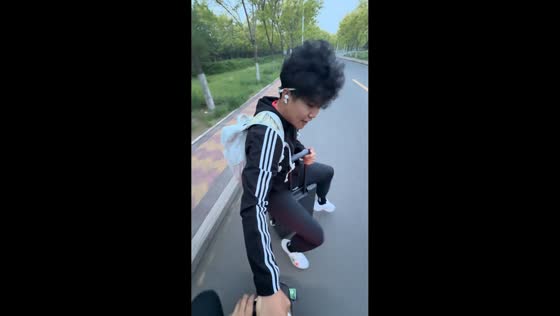 Man falls while riding suitcase pulled by motorcycle in Hebei, China