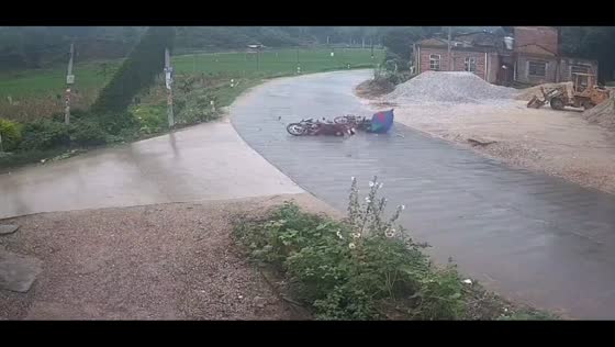 Motorcycles collide on rainy day in Guangdong, China