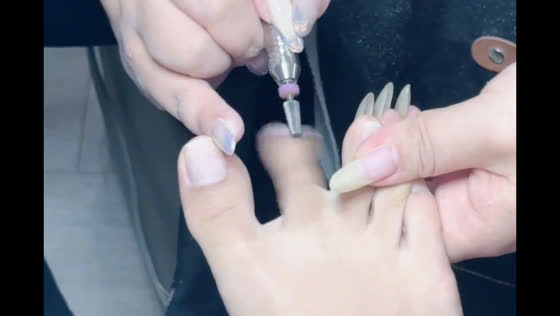 Manicure tool rotates with client's toe