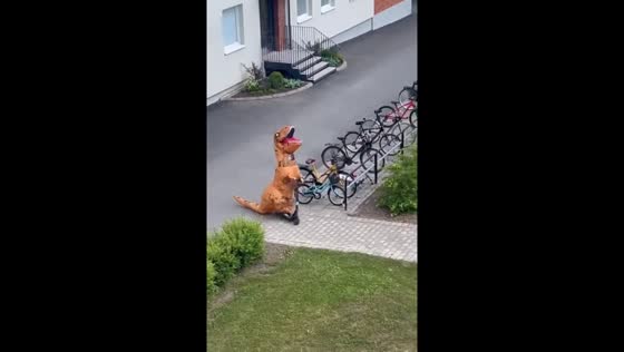 12-year-old rides scooter in dinosaur costume in Skövde, Sweden