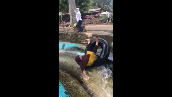 Mother falls off inflatable ring while sliding to the pool in Penengahan, South Lampung, Indonesia