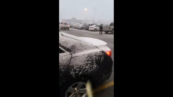 Gentle snowfall at a Kroger parking lot in Shepherdsville, Kentucky, USA