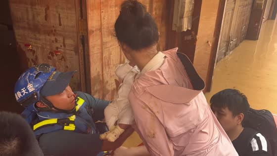 Newborn rescued from floodwaters during severe flooding in Guangxi, China