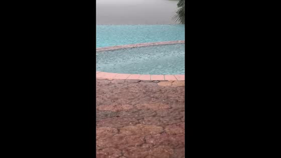 Torrential rain batters swimming pool during severe storm in St. Augustine, USA
