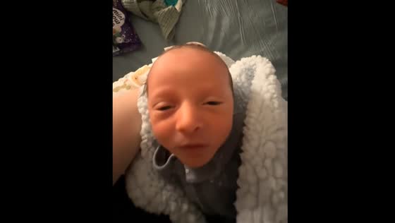 Baby moves head forward hilariously while being held