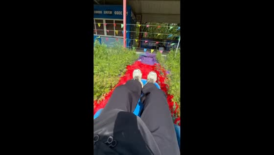 Man overshoots landing after fast slide on rainbow grass track in Liaoning, China