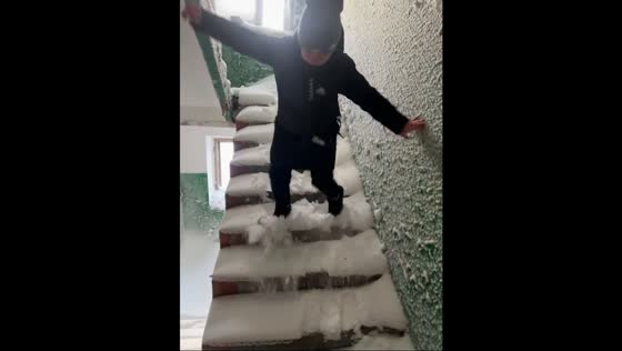 Man slips on snowy stairs in Vorkuta, Russia