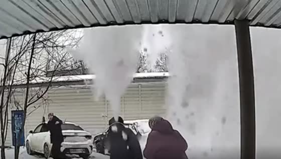A massive amount of snow fell on the two women standing in front of the house!