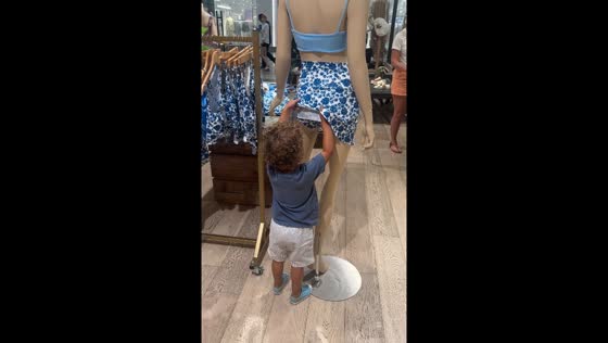 Child plays with mannequin in West Sacramento store