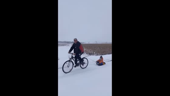 Winter joyride: grandfather creatively entertains grandson 