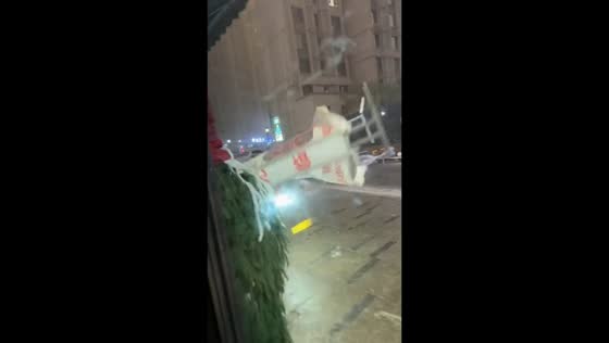 Strong winds push outdoor objects toward building in Xinjiang, China
