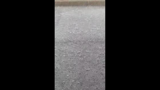 Hail and rain fall steadily in Elyria, Ohio, USA