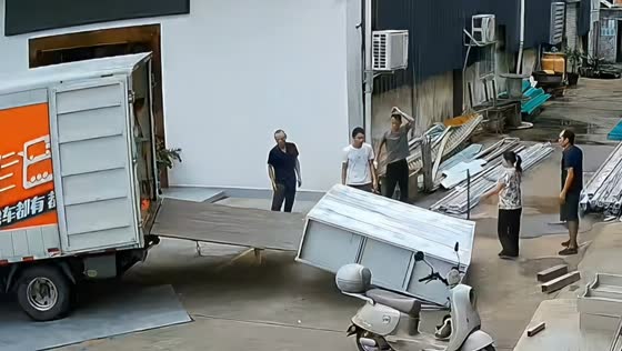 Truck tailgate collapses while workers load heavy cabinet in Beijing, China