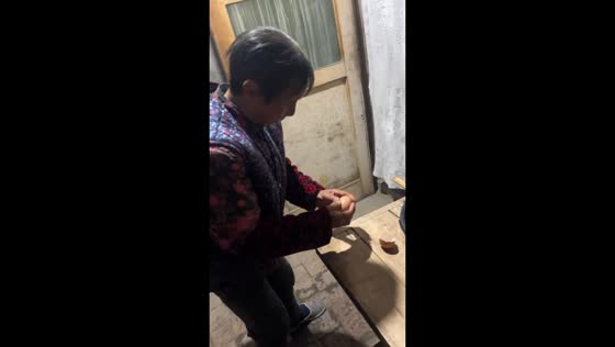 Grandma struggles with fake egg while cooking, Shaanxi, China