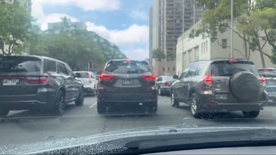 Heavy traffic flows calmly out of downtown in Honolulu, Hawaii, USA