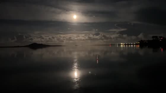 Full moon's radiant reflection on Burrow Beach