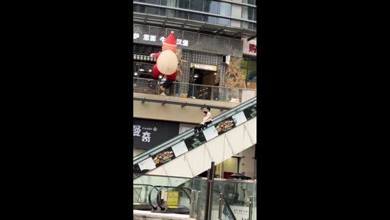 Mishap on escalator railings as two people slide together in Sichuan, China