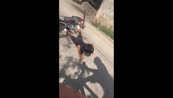 Kid struggles to balance two bikes and falls in Cebu, Philippines
