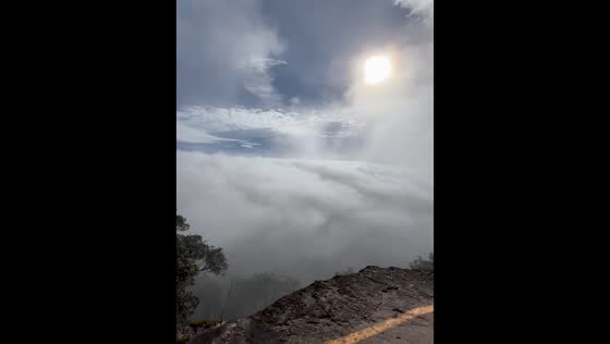 Fog drifts over mountain viewpoint in Prachinburi, Thailand