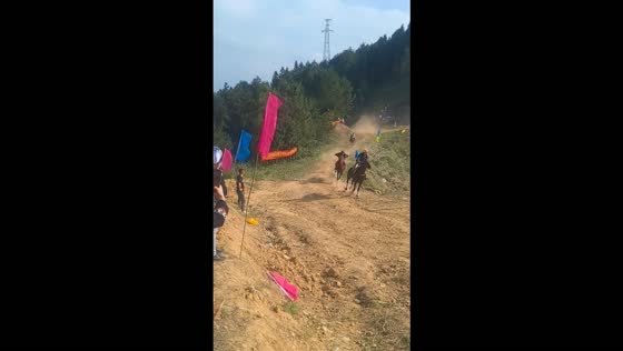 Horse and rider lose balance and fall during a downhill race in Guizhou, China