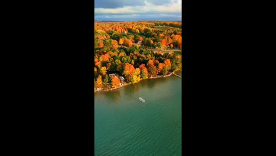 Serene autumn reflections in Alden, Michigan, USA, 