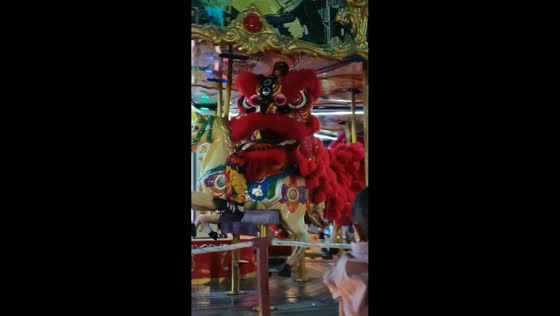 Lion dance performers ride carousel in Palembang, Indonesia