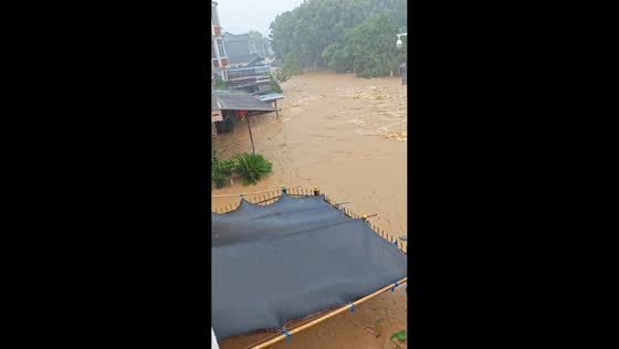 Muddy floodwaters sweep through neighborhood during Typhoon Dolphin in Zhejiang, China