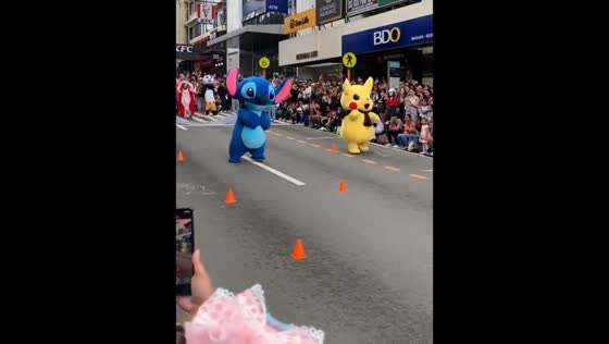 Pikachu outruns Stitch in a playful mascot race on Session Road in Baguio, Philippines