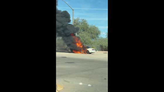 White sedan engulfed in flames at roadway intersection in Scottsdale, USA