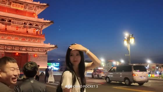 Passerby trips while smiling at woman posing for photo in Shanxi, China