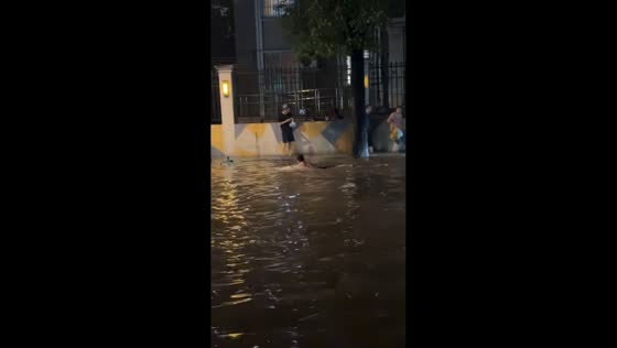 Man swims through floodwater in Shanghai, China
