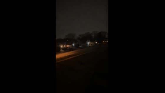 Tornado sirens echo through dark skies in Downers Grove, Illinois