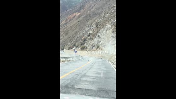 Falling rocks block mountain road in Tibet, China