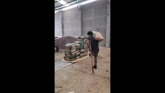 Man with one leg unloads truck using crutch in Guatemala